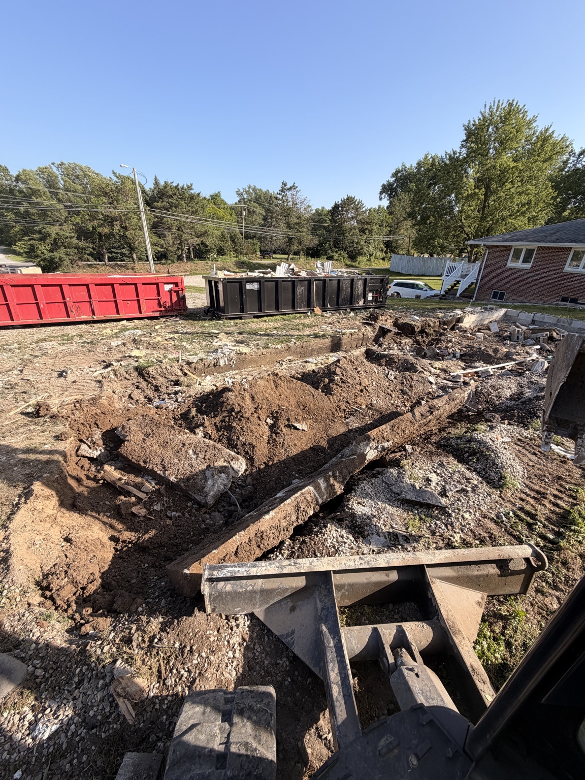 Foundation and concrete removal during a residential demolition project