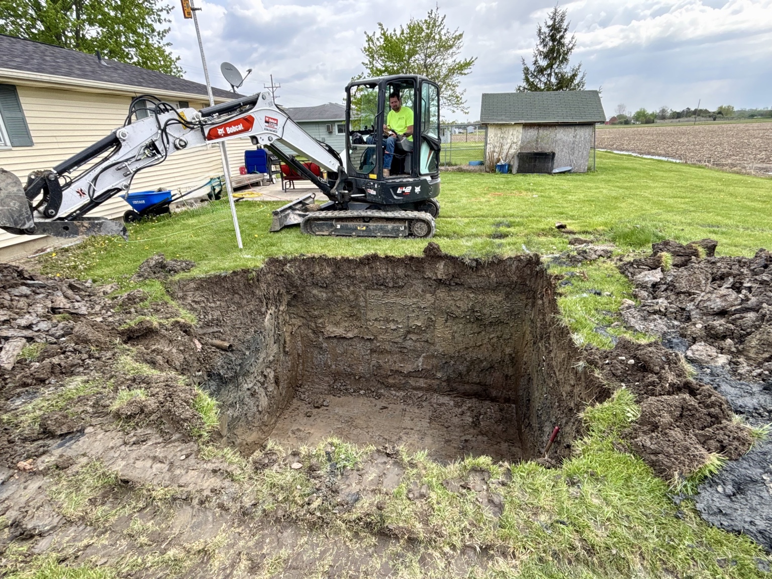 Foundation excavation beside a home